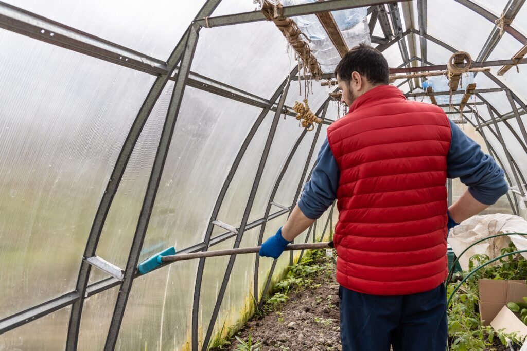 a man washing the greenhouse with a mop in the spr 2025 02 17 21 29 27 utc a man washing the greenhouse with a mop in the spr 2025 02 17 21 29 27 utc